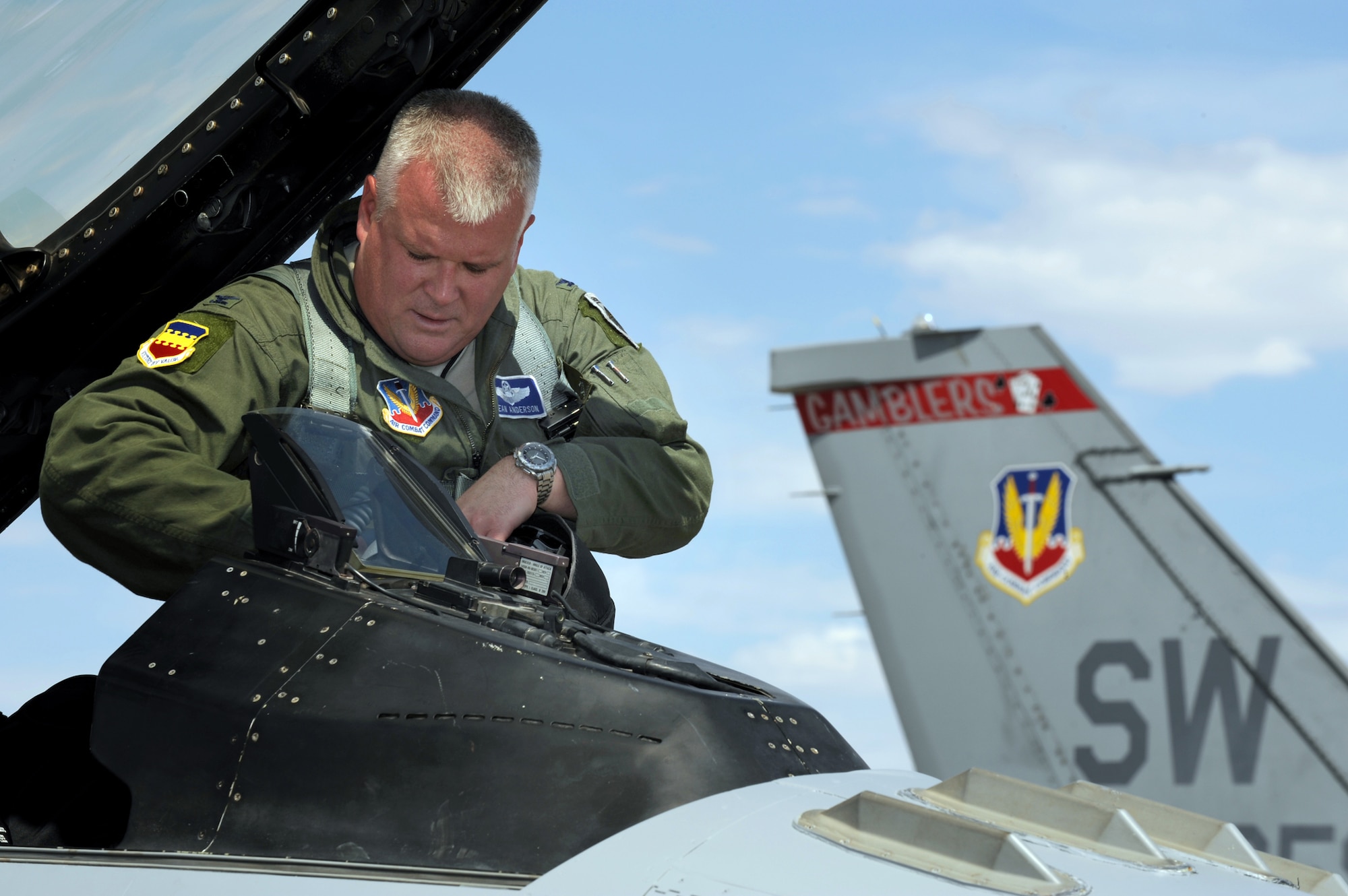 Colonel Dean "Norm" Anderson, 20th Fighter Wing vice commander at Shaw Air Force Base, S.C., climbs into an F-16CJ for a training mission at Nellis AFB, Nev., July 22, 2009.  Col. Anderson has the unique opportunity to fly, and command with his brother Lt. Col. Ross "Rosco" Anderson at the Red Flag 09-4 exercise in Las Vegas.  Col. Anderson, serving as the Red Flag AEW commander, and Lt. Col. Anderson, as the Red Flag AEW Operations Group commander.  (U.S. Air Force photo/Tech. Sgt. Michael R. Holzworth) 
