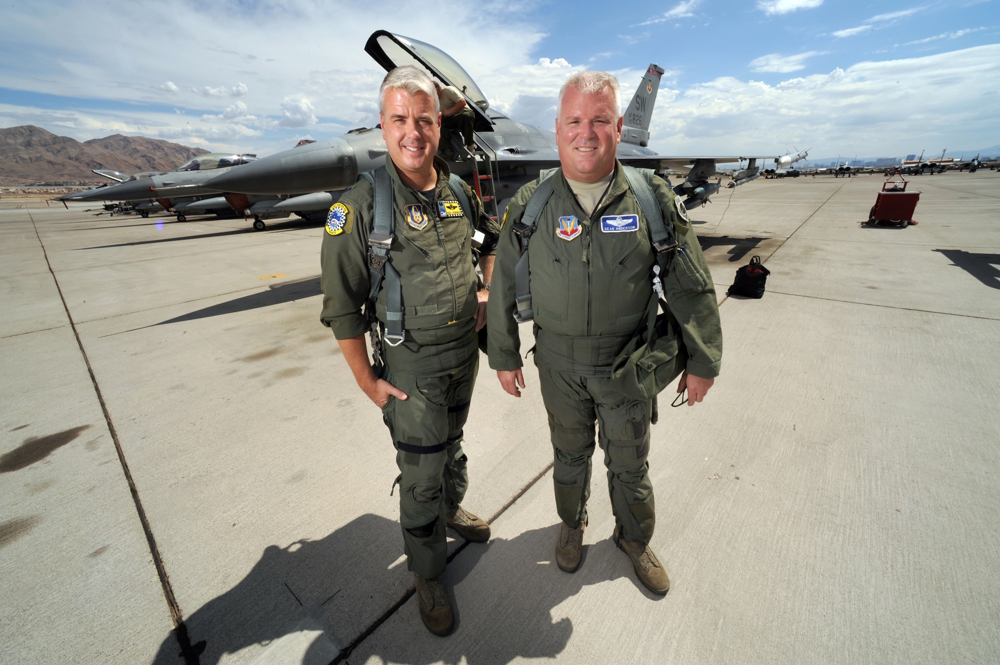 Colonel Dean "Norm" Anderson, 20th Fighter Wing vice commander at Shaw Air Force Base, S.C., and his younger brother,  Lt. Col. Ross "Rosco" Anderson, 482nd FW Operations Group commander and full-time reservist at Homestead Air Reserve Base in Homestead, Fla. Pose for a portrait on the Nellis AFB, Nev., flight line to signify the first time two brothers have been in command together at a Red Flag exercise.  The brothers were given the unique opportunity to take command of the Air Expeditionary Wing at the Red Flag 09-4 exercise in Las Vegas. Col. Anderson, serving as the Red Flag AEW commander and Lt. Col. Anderson, as the Red Flag AEW Operations Group commander.  "It's a huge honor, and a very big deal to me to be able to do this with my brother in a leadership position," said Lt. Col. Anderson. "Flying side by side in a squadron is one thing, but commanding is a huge honor." (U.S. Air Force photo/Tech. Sgt. Michael R. Holzworth)
