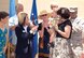 Cindy Murillo, Tinker’s Balfour Beatty Communities site manager, presented ceremonial keys to two Tinker families July 15 during the opening of the first completed houses built in base housing. Wesley Sohl, 2, held by his Air Force mom Elissa Sohl, and Navy wife Tiffany Malotte, far left, will be the first new residents to move in along Twining as construction continues on other homes along the street.  Taking part in the ribbon cutting and key presentations included Stacia Gillett, center in hat, wife of Maj. Gen.  David Gillett, Oklahoma City Air Logistics Center commander, and Col. Allen Jamerson, far right, 72nd Air Base Wing and Tinker installation commander. (Air Force photos by Margo Wright)
