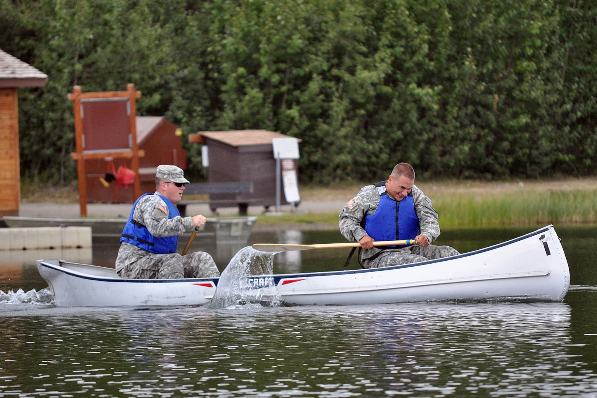 FORT RICHARDSON, Alaska -- Matthew Agee (left) and Travis Price, 59th Signal Company, paddle their canoe away from the start line July 17 in the canoe and run event of the Combat Cross-Country Series. (U.S. Army photo/John Pennell)