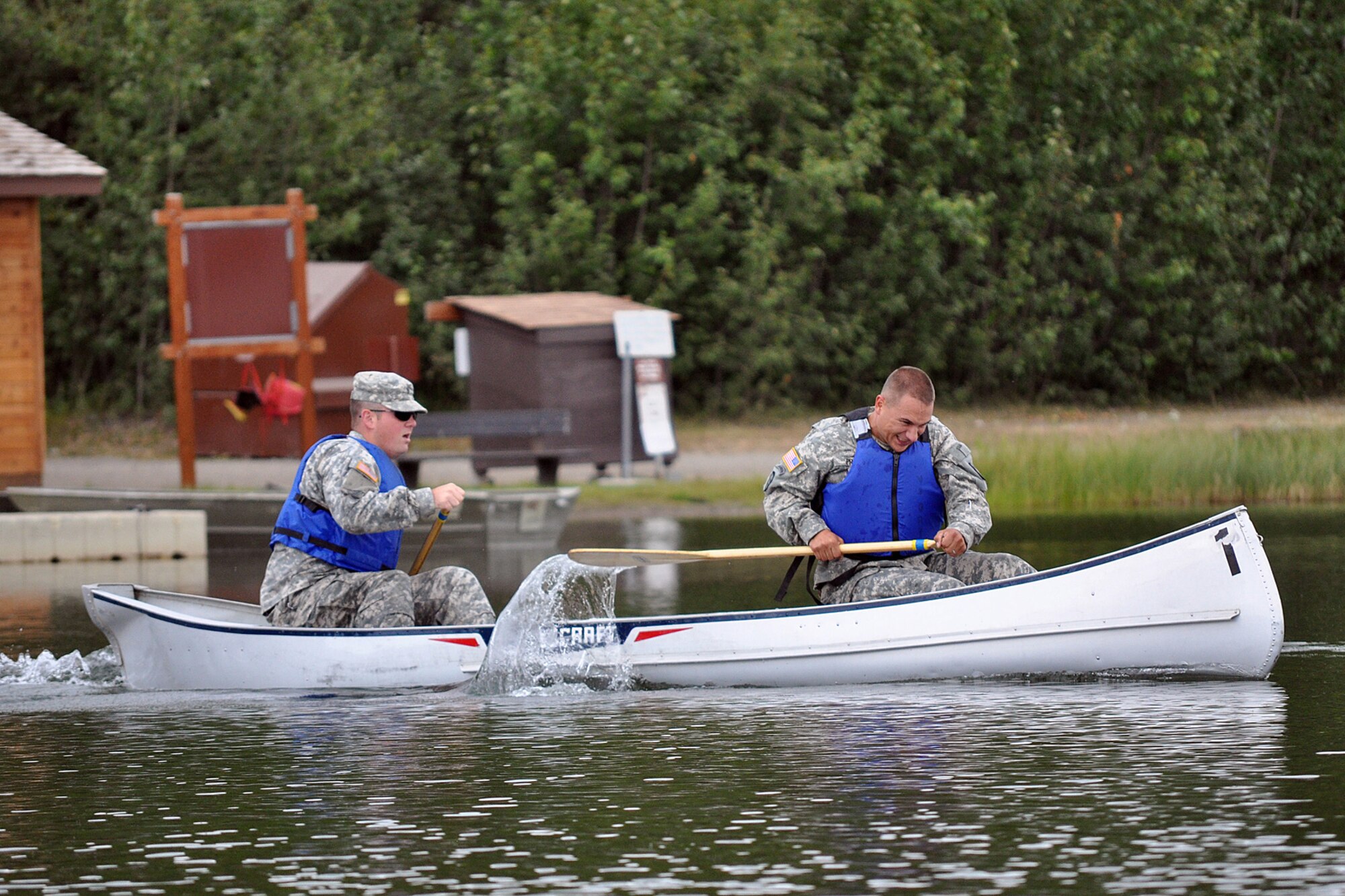 FORT RICHARDSON, Alaska -- Matthew Agee (left) and Travis Price, 59th Signal Company, paddle their canoe away from the start line July 17 in the canoe and run event of the Combat Cross-Country Series. (U.S. Army photo/John Pennell)