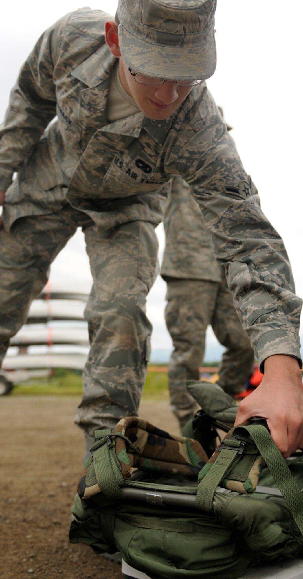 FORT RICHARDSON, Alaska -- Airman Dyllon Ezernack, 732nd Air Mobility Squadron, weighs his rucksack July 17 to ensure he qualifies with a minimum of weight of 35 pounds for the canoe and run at Otter Lake here. (U.S. Army photo/David Bedard)