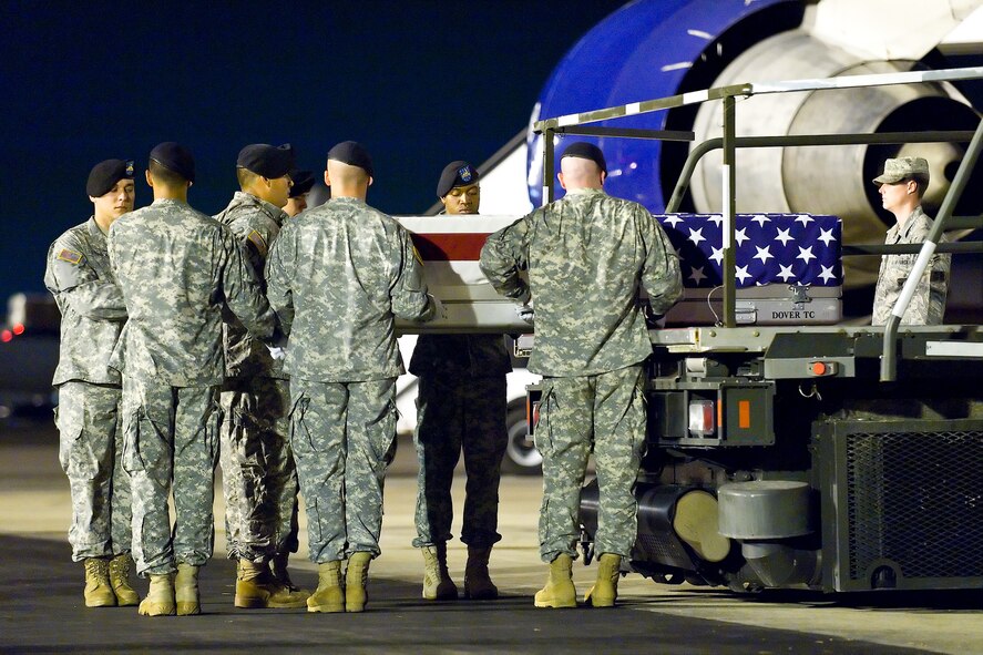 An Army carry team transfers the remains of Army Sgt. Gregory Owens, of Garland, Texas at Dover Air Force Base, Del., July 21. Sgt. Owens was assigned to the 4th Battalion, 25th Field Artillery (STRIKE), 3rd Brigade Combat Team, 10th Mountain Division (Light Infantry), Fort Drum, N.Y. (U.S. Air Force photo/Roland Balik)