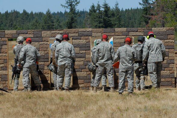 MCCHORD AIR FORCE BASE, Wash. -- Tech. Sgts. James Howard and Juan Felix, front, and Senior Master Sgt. Matthew Friedman and Staff Sgt. Kevin Ong, rear, 15th Security Forces Squadron, Hickam Air Force Base, Hawaii, carry a 225-pound litter patient dummy during an Air Mobility Rodeo 2009 event here July 21. Security Forces have historically provided flightline security and perimeter base defense; now, they are also called upon to operate “outside the wire.” This Rodeo event highlighted their readiness and ability so survive and operate in wartime. (U.S. Air Force photo/Staff Sgt. Carolyn Viss)