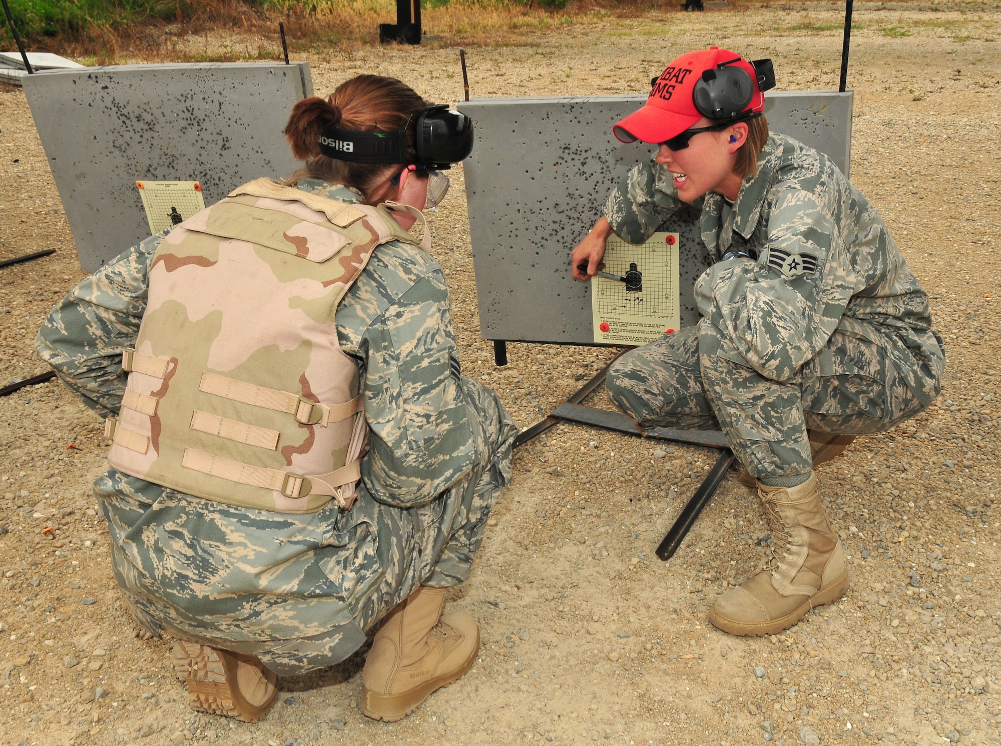 Senior Airman Leigh Downing, right, Combat Arms Apprentice for the WI Air National Guard's 115th Fighter Wing, reviews a shot grouping with Senior Airman Taryn Hermanson during M-16 rifle qualification at the Dane County Law Enforcement Training Center June 29.  Personnel assigned to Combat Arms Training and Maintenance assure that all unit members receive adequate weapons training prior to Aerospace Expeditionary Force deployments.  (U.S. Air Force photo by Master Sgt. Paul Gorman)