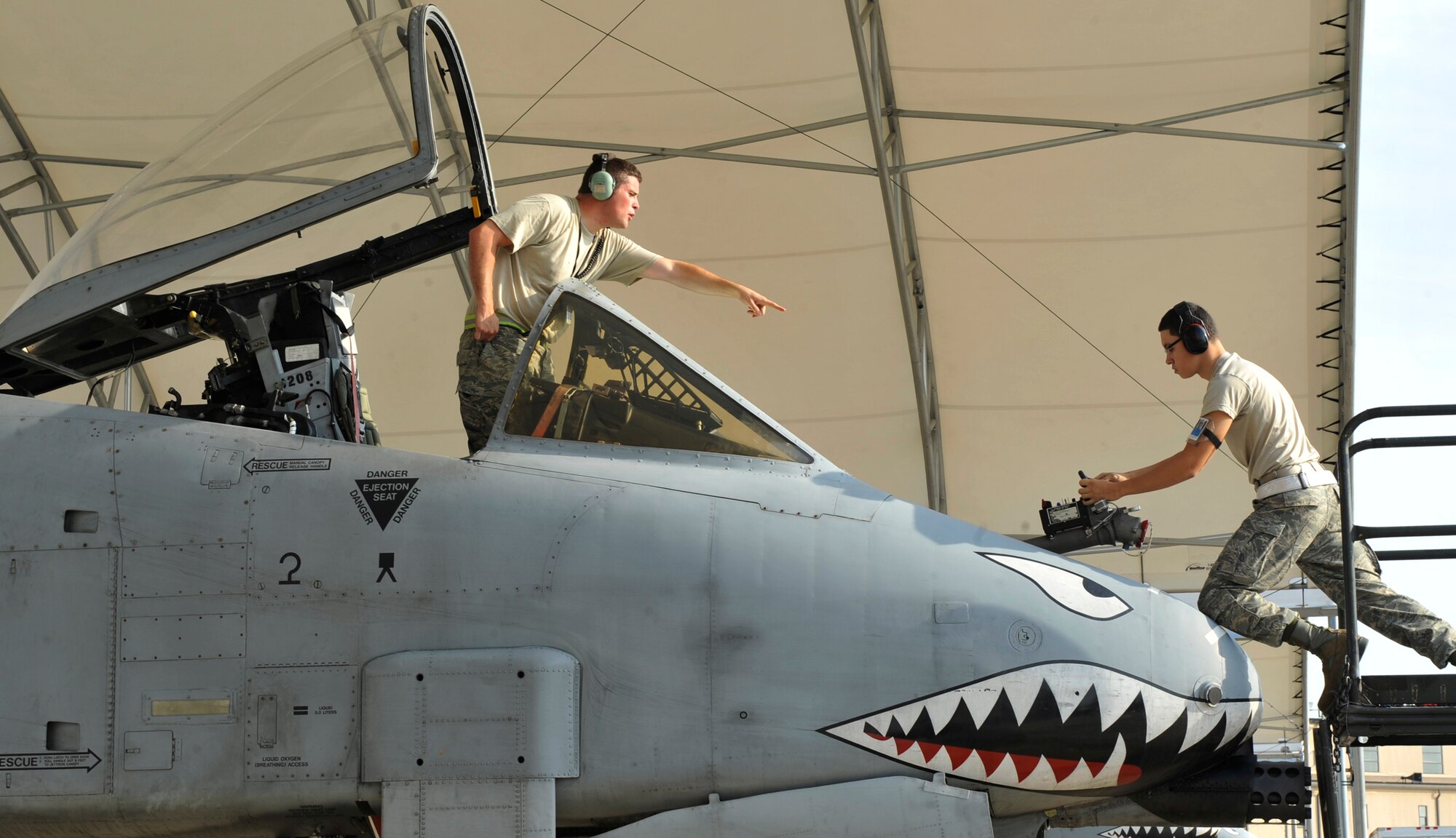 MOODY AIR FORCE BASE, Ga. -- Staff Sgt. Nathan Flitcraft, 23rd Component Maintenance Squadron aircraft fuels systems, instructs Airman 1st Class Armando Del Valle II, 23rd CMS aircraft fuels systems, on proper techniques while performing an in-flight refuel check here July 22. They perform the check to prepare for a possible deployment. (U.S. Air Force photo by Senior Airman Schelli Jones)
