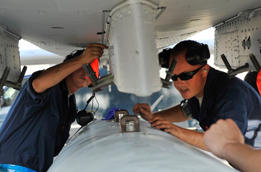 MOODY AIR FORCE BASE, Ga. -- Senior Airman Edward Metcalf and Staff Sgt. David Clifford, 23rd Aircraft Maintenance Squadron dedicated crew chiefs, prepare to hang an external fuel tank on a A-10C Thunderbolt II.  (U.S. Air Force photo by Senior Airman Schelli Jones)