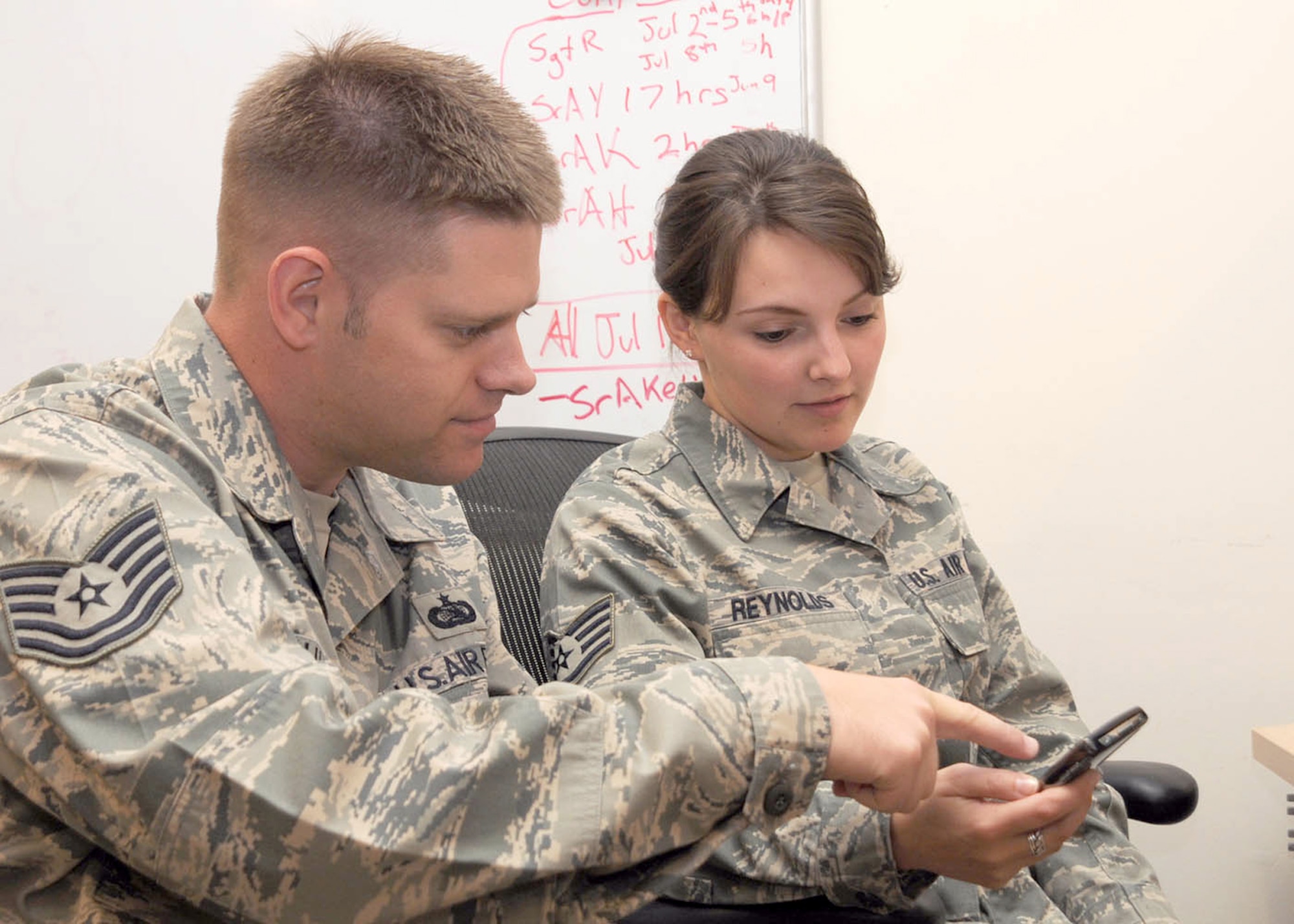 AVIANO AIR BASE, Italy -- U.S. Air Force Reservist Tech. Sgt. Larry Mulder, a communications computer operator assigned to the 910th Communications Flight, Youngstown Air Reserve Station, Ohio, guides Staff Sgt. Rachel Reynolds, a communications computer operator assigned to the 31st Communications Squadron Configuration Management Team here, through a Blackberry encryption mismatch that caused a base wide Blackberry outage July 15, 2009. Tech. Sgt. Mulder, on annual tour with the 31st CS, helped resolve the Blackberry outage that hampered base communications for eight days.  (U.S. Air Force photo by Tech. Sgt. Rick Lisum)