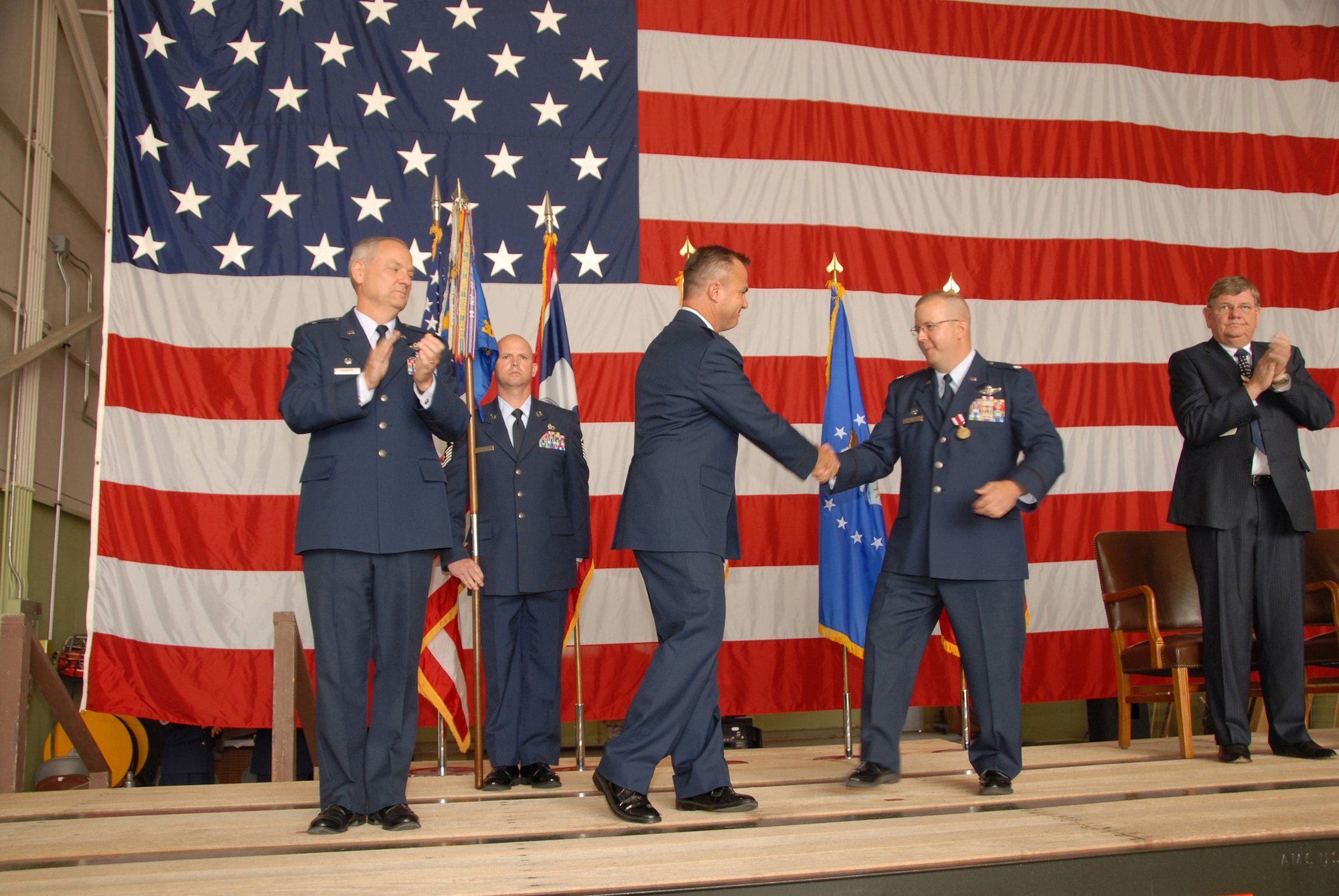 Lt. Col. Eric Mayheu and Lt. Col. Jeffrey Devore congratulate one another after Colonel Mayheu assumed command of the 30th Airlift Squadron, 153rd Airlift Wing, Wyoming ANG, on July 10. Col David Kasberg, 19th Operations Group commander, presided over the ceremony whose attendees included Wyoming governor Dave Freudenthal, civilain and military officials, as well as members of the Wyoming ANG. (U.S. Air Force photo by Senior Master Sgt. Paul Mann)