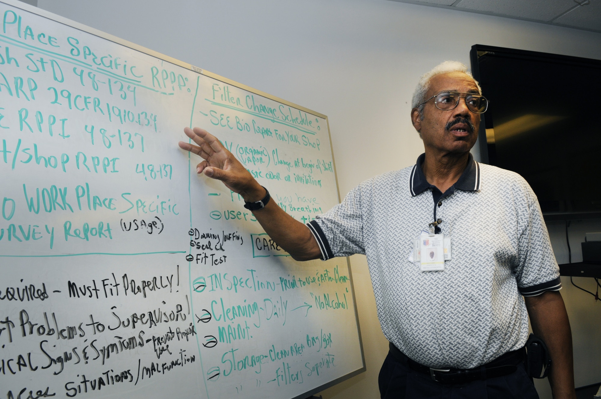 Joseph Brothers, in the shop's classroom, explains that each person that wears a mask has to come in for annual training to learn the Occupational and Health Administration regulations for mask use. U. S. Air Force photo by Sue Sapp