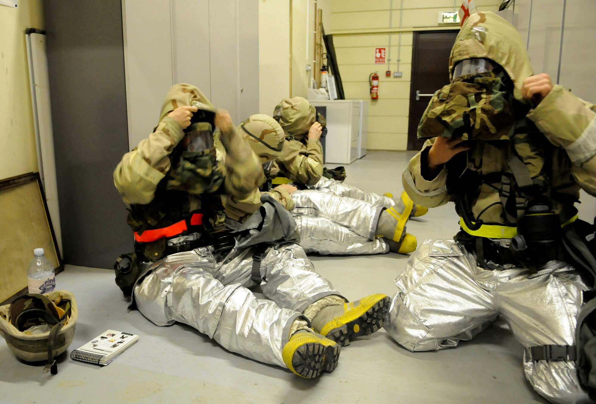 RAF MILDENHALL, England – Firefighters from the 100th Civil Engineer Squadron don specialized chemical suits and masks during a simulated attack July 22.  The attack was part of several that occurred during a phase-two exercise, designed to practice warfighting procedures.  (U.S. Air Force photo by Staff Sgt. Christopher L. Ingersoll)
