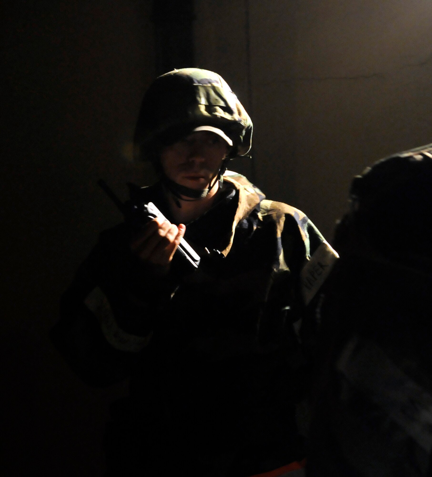 RAF MILDENHALL, England – Senior Airman Christopher Sherfinski, 100th Civil Engineer Squadron, radios his chain of command about the status of a door alarm he is repairing during a phase-two exercise July 21.  (U.S. Air Force photo by Staff Sgt. Christopher L. Ingersoll)
