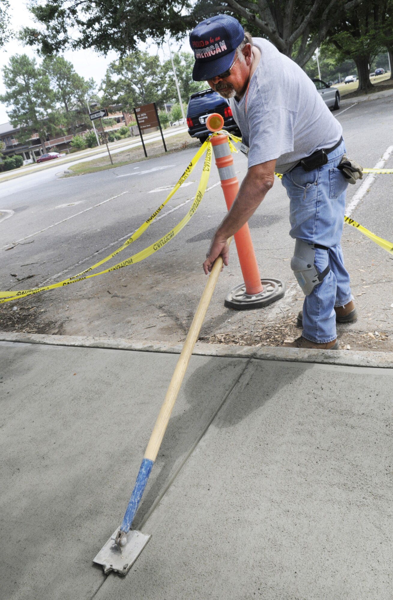 Rick Clark, 78th CES mason, puts finishing touches on a  sidewalk in front of Bldg. 936. U. S. Air Force photo by Sue Sapp