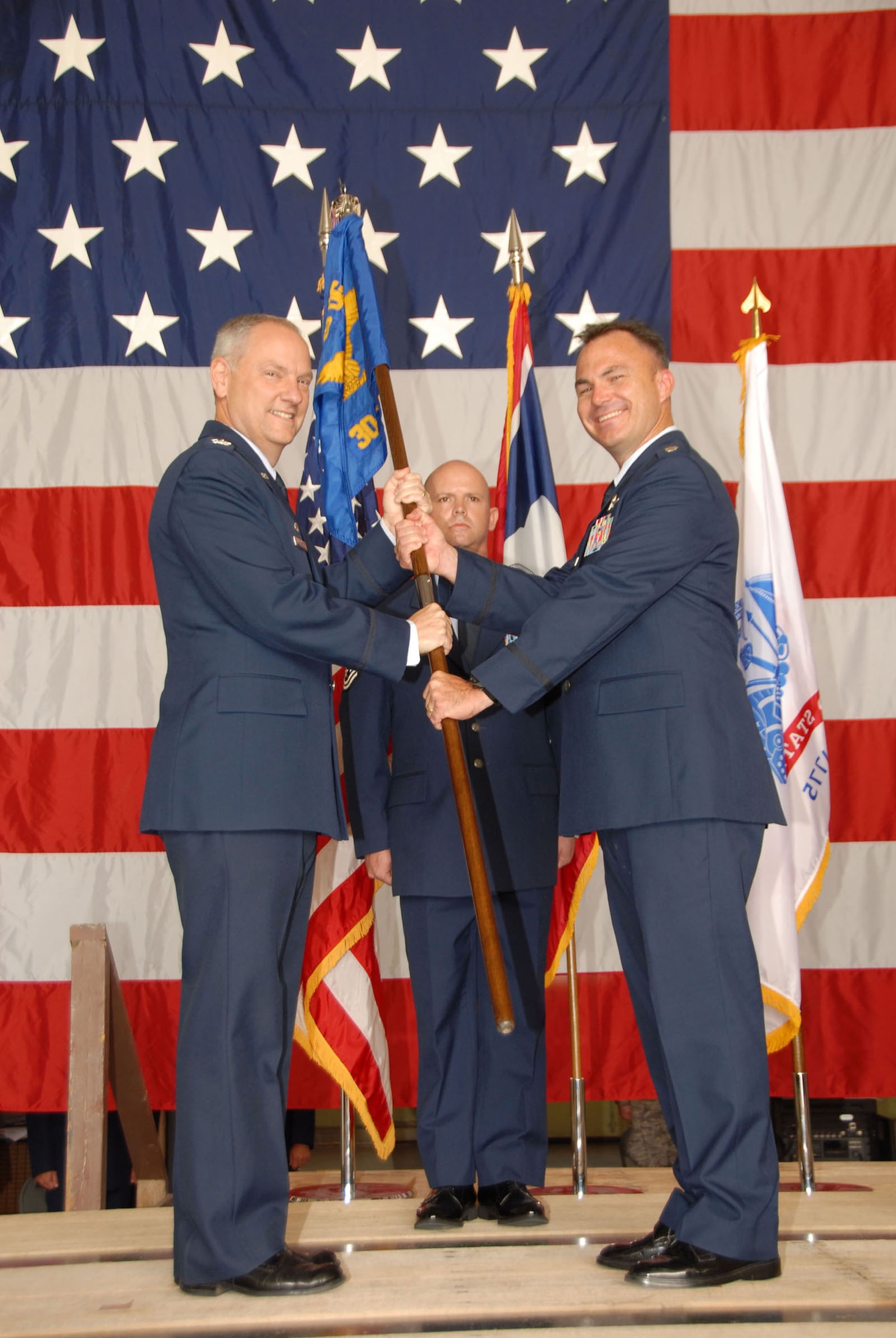 Lt Col. Eric Mayheu (right) assumes command of the 30th Airlift Squadron, 153 Airlift Wing, Wyoming Air National Guard, July 10. Col. David A. Kasberg, 19th operations group commander, was the ceremony's presiding officer. The 30th AS, the Air Force's first active-associate unit, welcomed it's third commander to Cheyenne, Wyo., with a week of command related activities culminating with the change of command. (U.S. Air Force photo by Senior Master Sgt. Paul Mann)