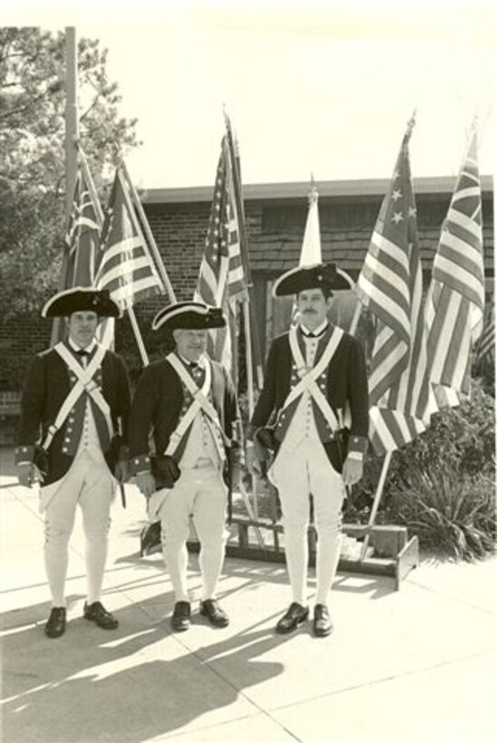 Steve Mercer, Richard McIver and an unknow Coyote in their 1976 costumes and the flags they used to show the history of the United States.