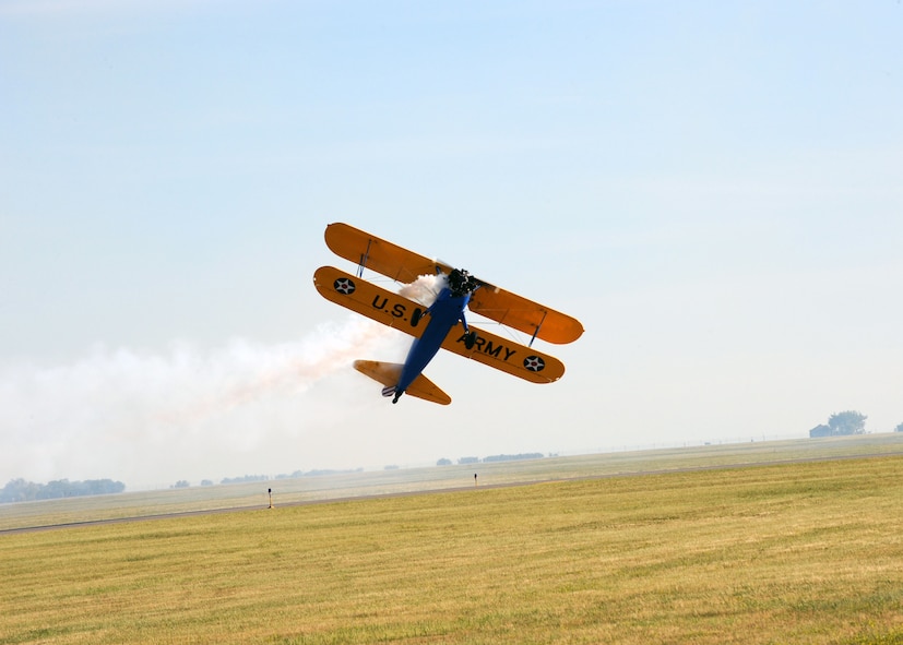 MINOT AIR FORCE BASE, N.D. -- John Mohr demonstrates the maneuverability of his PT-17 Stearman aircraft by flying the plane sideways in front of the crowd at Northern Neighbor’s Day here July 18. Thousands of people from the base and local community turned out to watch the 2009 Northern Neighbors Day, which came through on its promise to wow spectators with amazing aerial maneuvers, nail-biting choreography, historic displays and much more.  (U.S. Air Force photo by Staff Sgt. Keith Ballard)