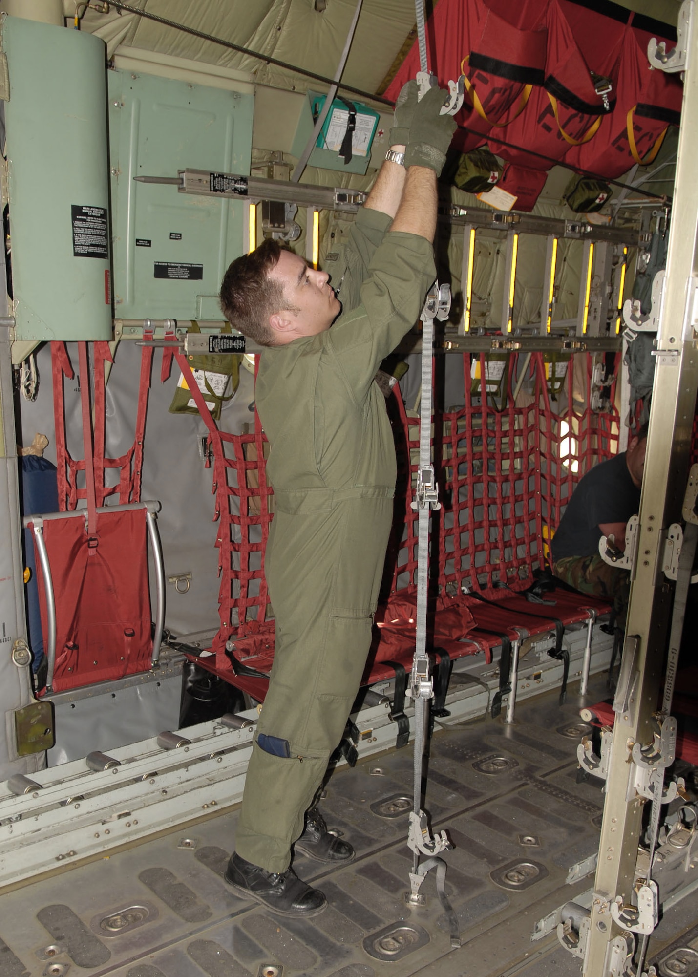 Tech. Sgt. Tom Hough checks litter stanchion straps on a C-130 Hercules July 19 at El Tari Air Force Base, Indonesia. The straps allow the C-130 to transport medical patients. U.S. Airmen in Indonesia as part of Operation Pacific Angel 2009 practiced loading patients with the Indonesian military and local doctors. Sergeant Hough is a loadmaster from Kulis Air National Guard Base, Alaska. (U.S. Air Force photo/Senior Master Sgt. Russell Dodson) 
