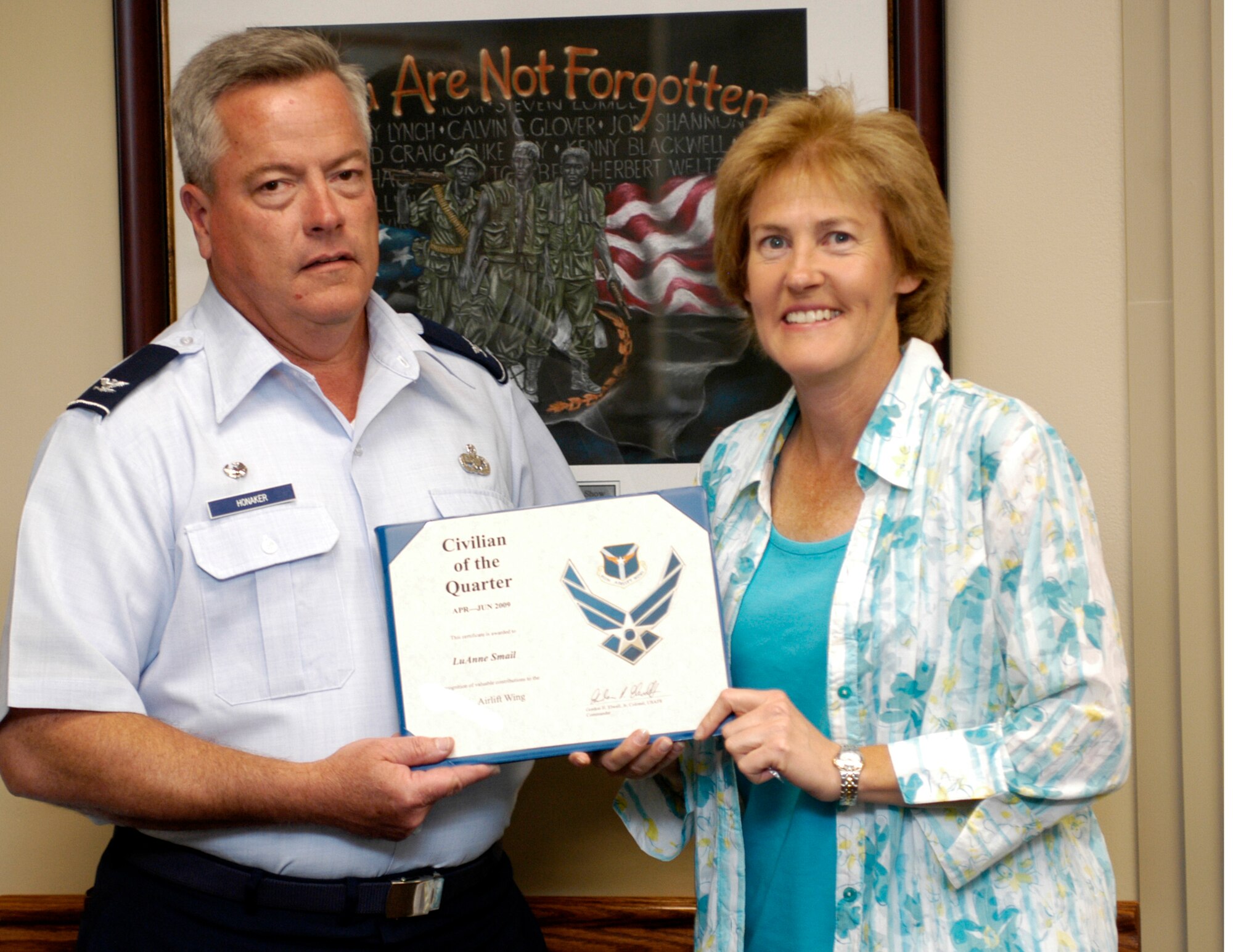 Ms. LuAnne Smail, receives Civilian of the Quarter, 2nd Quarter, award from Col. Kenneth Honaker, 911th Maintenance Group commander, July 22, 2009.  Ms. Smail has worked as the 911 MXG commander's secretary for nine years.  She also received a Civilian of the Quarter award in 2007 (Photo by Tech. Sgt. Scott J. Pryor.)
