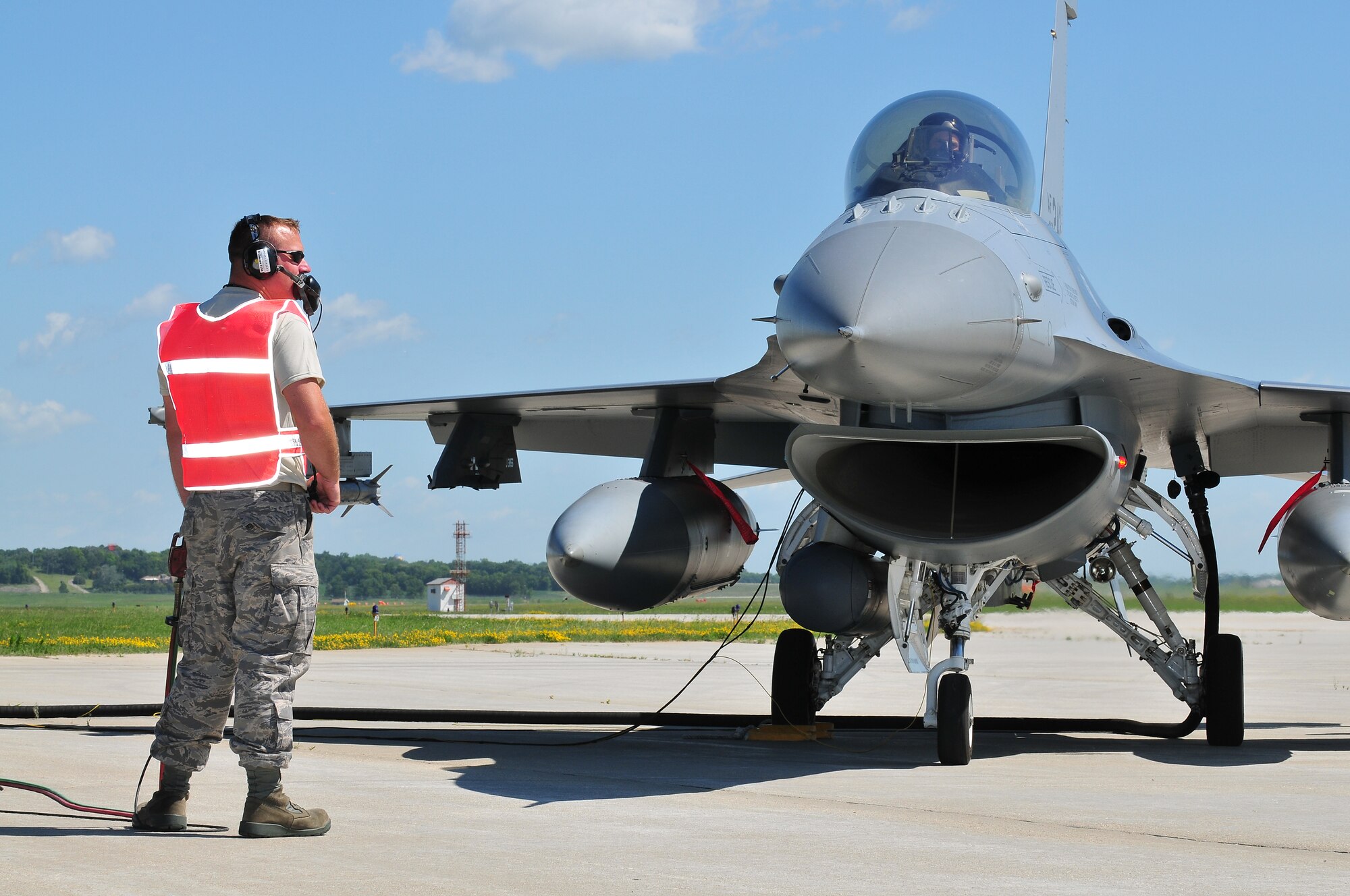 Tech. Sgt. Eric Chartre, F-16 Aircraft Maintenance Specialist for the WI Air National Guard's 115th Fighter Wing performs the lead position for hot pit refueling operations at Dane County Regional Airport in Madison, WI on June 28, 2009. Hot pit refueling operations provide rapid sortie generation by allowing 115FW F-16 aircraft to refuel and return to flight without shutting down their engines.  (U.S. Air Force photo by Master Sgt. Paul Gorman)