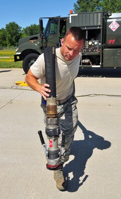 Staff Sgt. John Brown, refueling unit mechanic for the Air National Guard's 115th Fighter Wing in Madison, WI, readies the refueling hose for hot pit refueling operations at Dane County Regional Airport on June 28, 2009. Hot pit refueling provides rapid sortie generation by allowing 115FW F-16 aircraft to refuel and return to flight without shutting down their engines. (U.S. Air Force photo by Master Sgt. Paul Gorman)