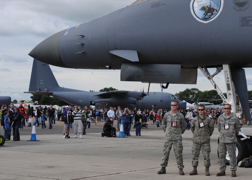 The B-1 Bomber maintenance crew poses for a fan in front of their jet during the Royal International Air Tattoo here July 18. The air show was open to the public for July 18 and 19. The B-1 crew stayed busy giving tours of the static display and answering questions from the spectators. (U.S. Air Force photo by Senior Airman Jennifer Romig)