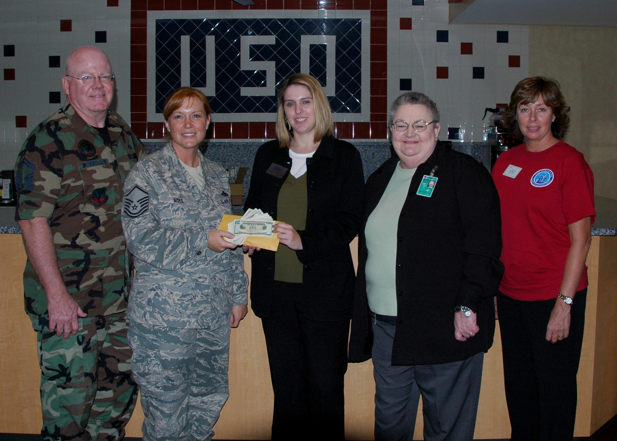 Units from the 131st Bomb Wing Missouri Air National Guard at Lambert-Saint Louis collected over $1000.00 for the U.S.O. at Lambert International Airport.  They presented U.S.O. personnel a monetary donation and many needed supplies for daily operations.  The U.S.O. hosts on average 10-12,000 transient military members and dependents monthly at two locations in Lambert Airport.  "The U.S.O provides support to all branches of service and depends entirely on donations and volunteers." said Master Sgt Jennifer Noll, 131st Communications Flight,  "We at the 131st challenge all Guard units in our state to meet or exceed our donation efforts for this worthy cause. For information on donations and how to volunteer, go to www.usomissouri.org."  Pictured (l to r) Senior Master Sgt John Morrissey, 131st Civil Engineering Squadron, Master Sgt Jennifer Noll,  Ms. Jennifer Zarzecki, USO of MO Exec Assistant, Ms. Marla Duda, Dir. Facilities & Volunteer Services, Ms. Tammy Caldwell, 131st Civil Engineering Squadron.  (Photo by Master Sgt. Mary-Dale Amison) 