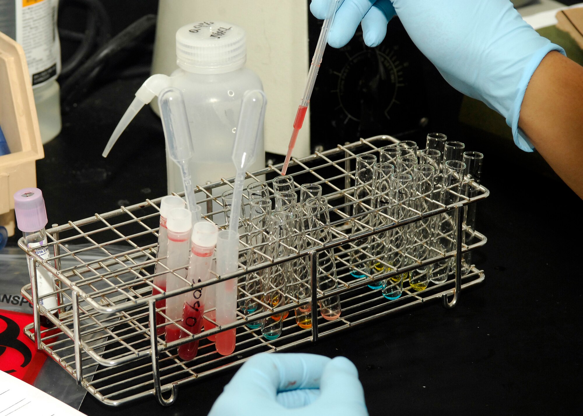BAGRAM AIRFIELD, Afghanistan - Staff Sgt. Rudyard Ganuelas, a medical laboratory technician from Joint Task Force MED east/455th Expeditionary Medical Group, puts a drop of blood into three different vials of chemicals to test and discover what blood type a patient is, here July 22. Sergeant Ganuelas hails from the Philippines and in deployed from Travis Air Force Base, Calif. (U.S. Air Force photo/Senior Airman Felicia Juenke)