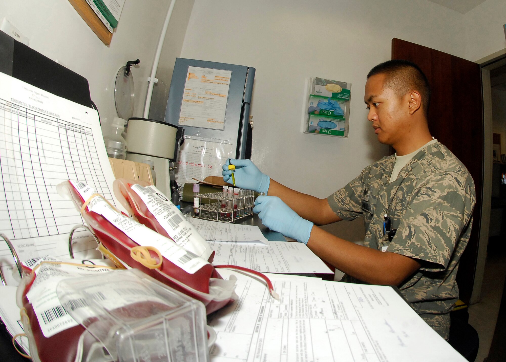 BAGRAM AIRFIELD, Afghanistan - Staff Sgt. Rudyard Ganuelas, a medical laboratory technician from Joint Task Force MED east/ 455th Expeditionary Medical Group, drops different types of chemicals into vials, which is the first step of testing blood to see what type of blood the patient has, here July 22. The Craig Joint Theater Hospital has 10 Intensive Care Unit beds for treating patients in theater, those needing more care are air evacuated to Germany. Sergeant Ganuelas hails from the Philippines and in deployed from Travis Air Force Base, Calif. (U.S. Air Force photo/Senior Airman Felicia Juenke)