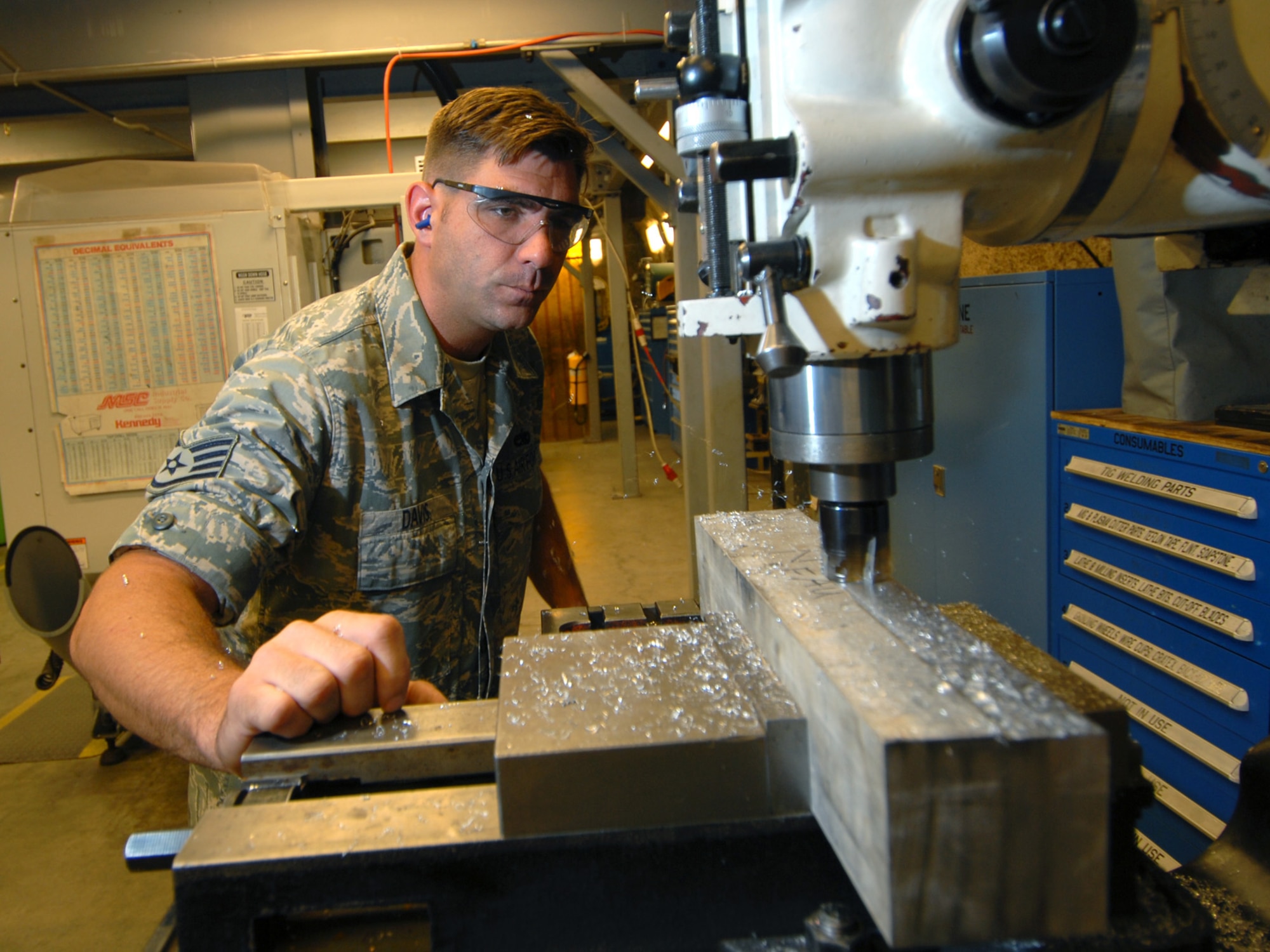 Staff Sgt. Roger Davis, 379th Expeditionary Maintenance Squadron aircraft metals technology craftsman, mills aluminum stock to size, here, July 23. Sergeant Davis routinely machines, welds, locally manufactures and repairs aircraft structural components in accordance with aircraft technical orders for seven different airframes, ensuring Air Force, joint and coalition aircraft are mission capable. Sergeant Davis is a native of Harrisburg, Pa., and is deployed from Royal Air Force Mildenhall, England, in support of Operations Iraqi and Enduring Freedom.  (U.S. Air Force Photo/Tech. Sgt. Jason W. Edwards)