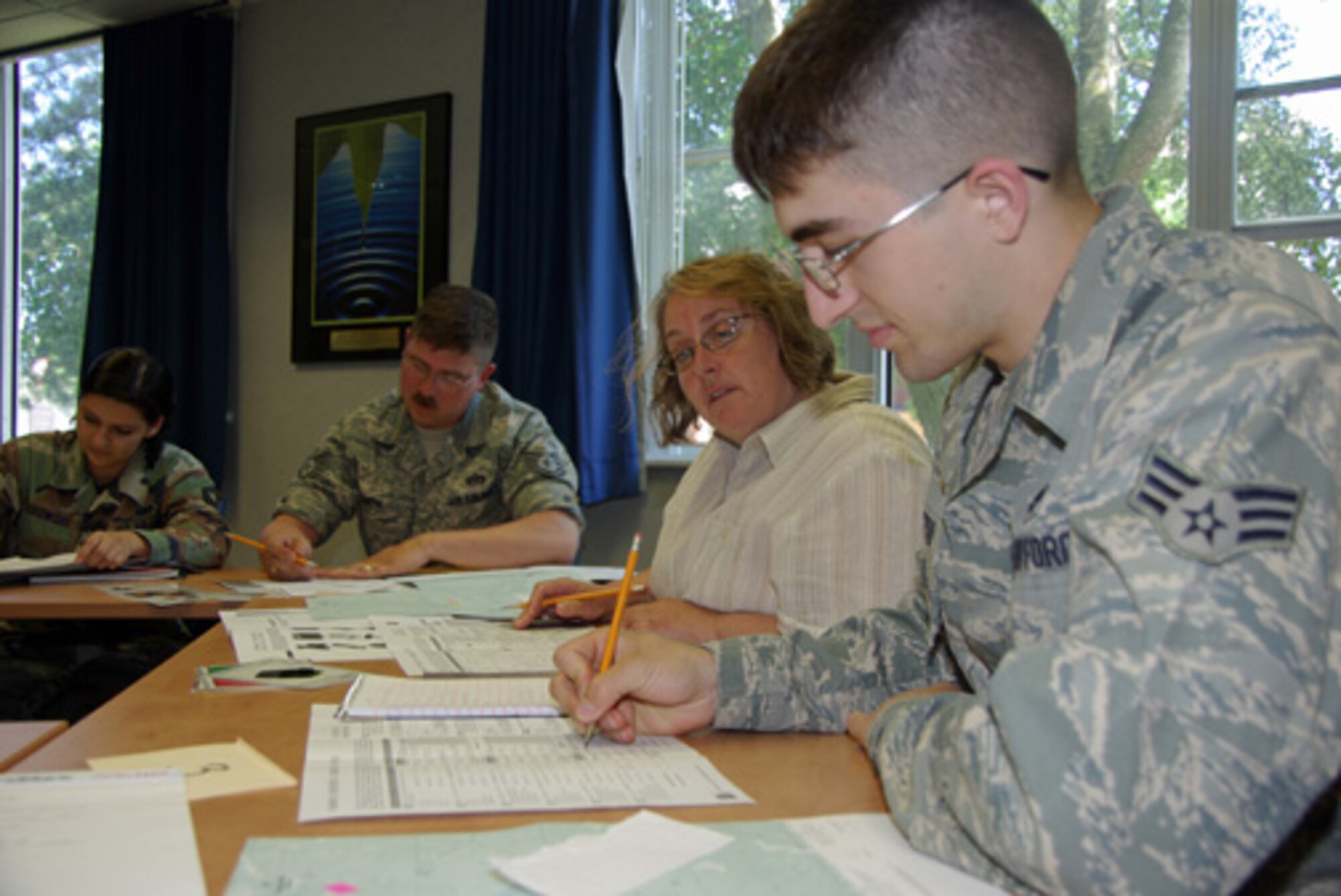 RAF Mildenhall, ENGLAND – Airman 1st Class Jazz Sutto, 100th Maintenance Squadron and Catherine Fyre, mother of Master Sgt. Jessica Hensley, Professional Development Center superintendent, complete an exercise in group dynamics at the PDC here. The exercise required participants to problem solve individually and as a team. Anyone interested in being a part of the next class being held Aug. 4, can call the PDC at 238-5933.  (U.S. Air Force photo by Tech. Sgt. Marelise Wood)