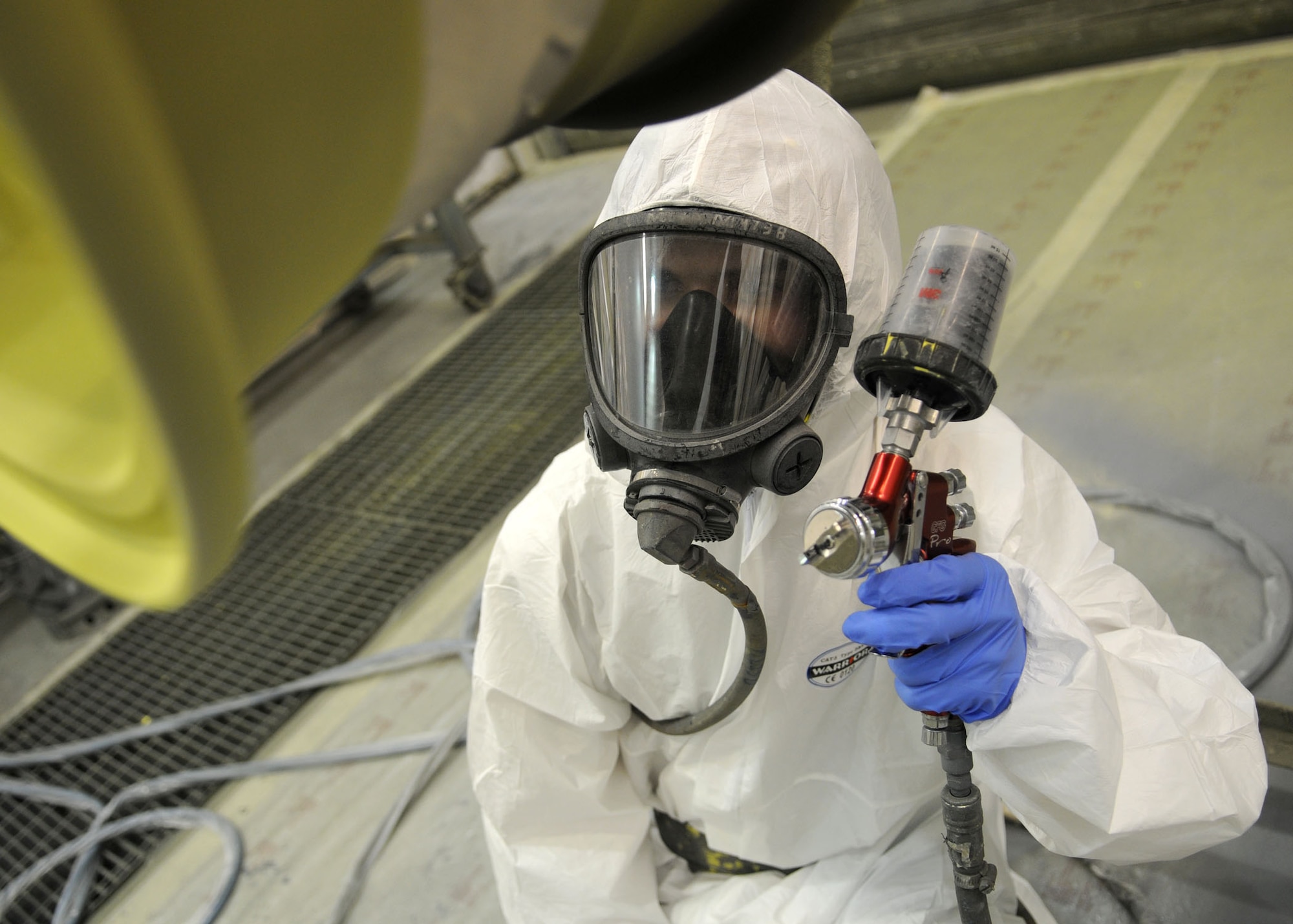 RAF MILDENHALL, England--Airman 1st Class Robert Greenwell, 100th Maintenance Squadron, aircraft structural maintenance technician, uses a paint gun to apply flat black paint to a set of aircraft wheels June 16, 2009. Airman Greenwell applies the paint as a protective coating to prevent corrosion while also matching the aircraft paint scheme. (U.S. Air Force photo by Staff Sgt. Jerry Fleshman)