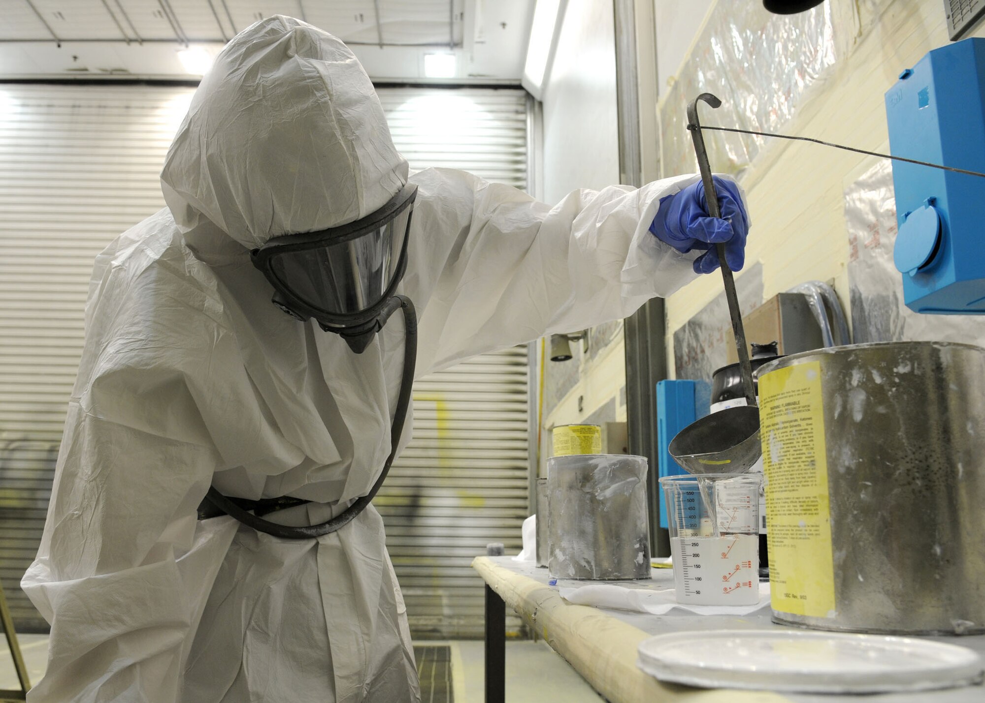 RAF MILDENHALL, England--Airman 1st Class Robert Greenwell, 100th Maintenance Squadron, aircraft structural maintenance technician, mixes catalyst into white paint to accelerate the drying process after application June 16, 2009. Airman Greenwell ensures to use precise measurements for proper cohesion because too much or not enough can affect the drying process. (U.S. Air Force photo by Staff Sgt. Jerry Fleshman)