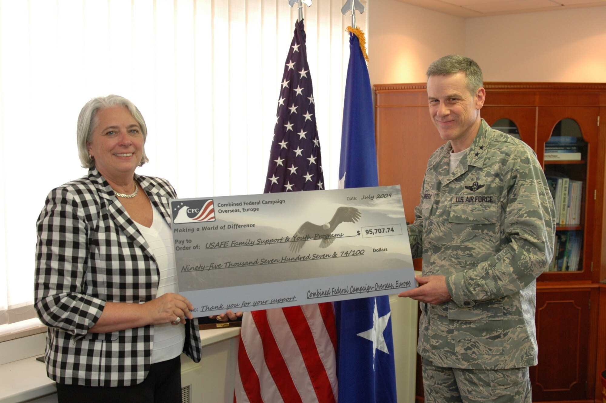 Ms. Renee Acosta, President and CEO of the Dept. of Defense’s Combined Federal Campaign Overseas management organization Global Impact, presents a ceremonial check for more than $95,000 Jul. 21 to Maj. Gen William Chambers, U.S. Air Forces in Europe vice commander.  The check represents donations that civilian and military employees in USAFE donated to Family Support and Youth Programs through CFC-O during the 2008 campaign. (USAF photo/ Master Sgt. Corey Clements)
