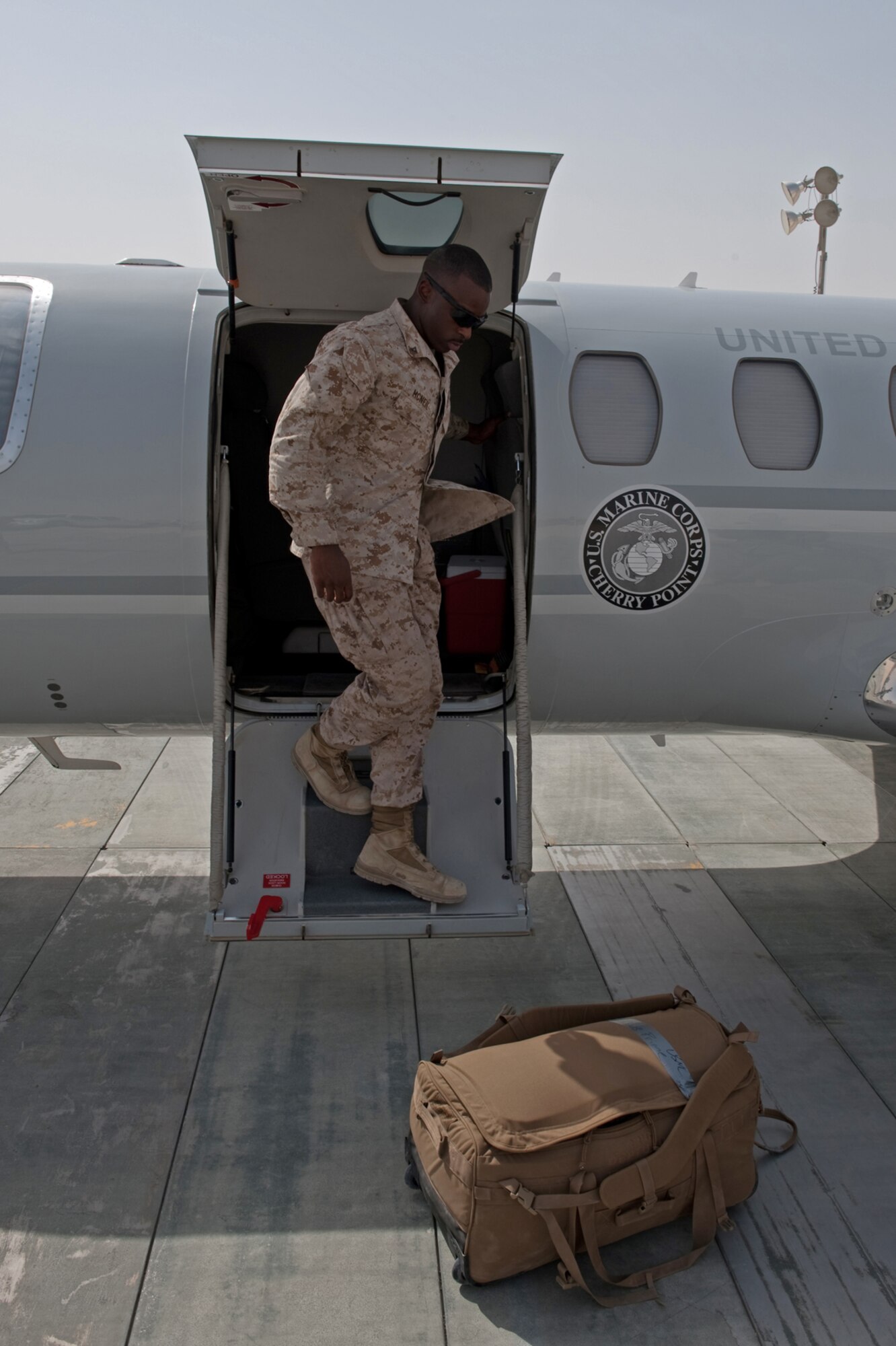 Lance Cpl. Antonio McNeil, Marine Air Group 40, boards a UC-35 that will transport him to his duty area, July 16, in Southwest Asia. The UC-35 provides quick airlift capabilities for personnel and equipment throughout Southwest Asia. Corporal McNeil is a native of Williamsboro, N.J., and is deployed from in support of Operations Iraqi and Enduring Freedom. (U.S. Air Force Photo/Staff Sgt. Robert Barney)