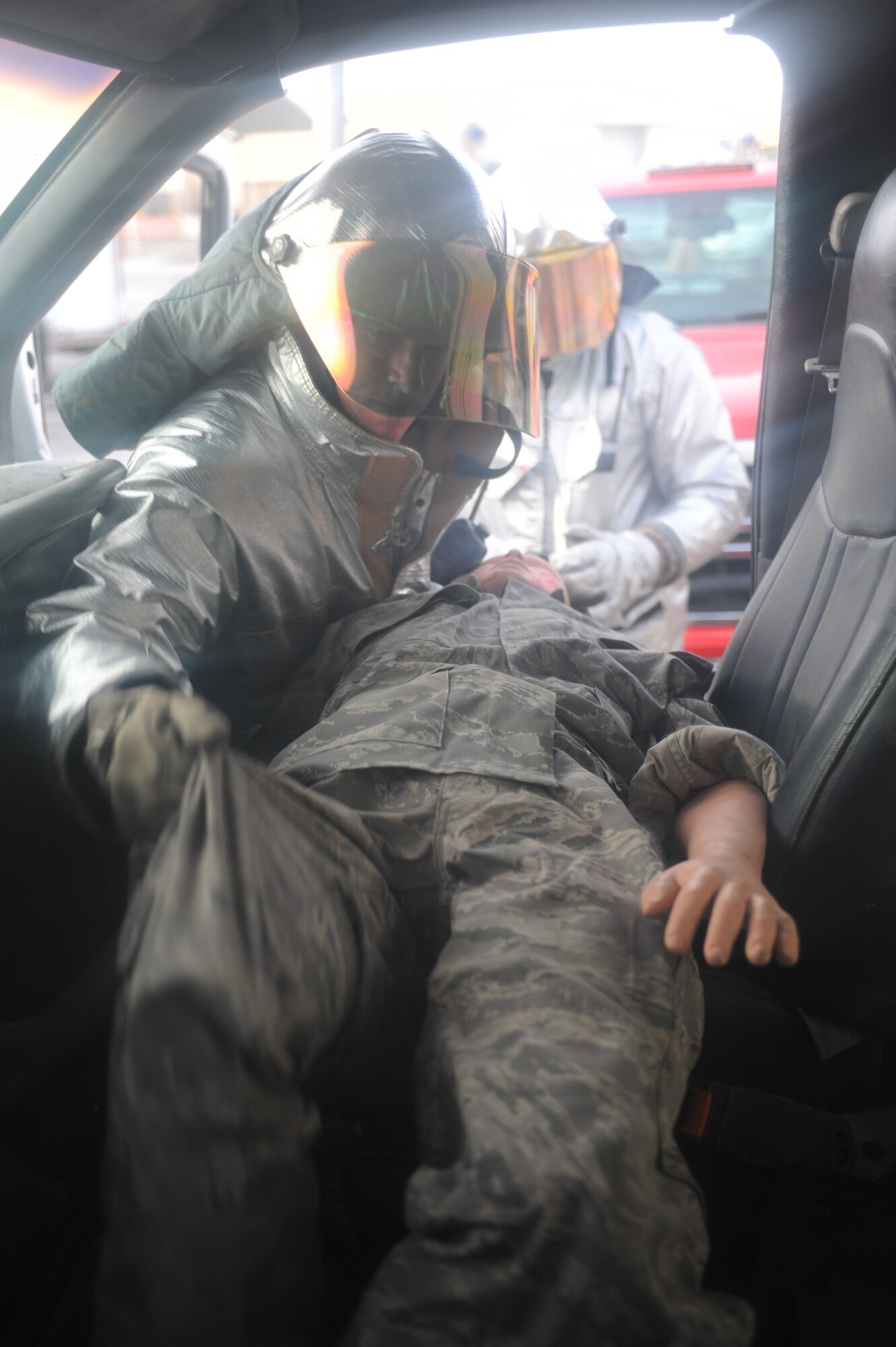 SOUTHWEST ASIA - Staff Sgt. Kevin Gantt and Senior Airman Kyle Dobler, 380th Expeditionary Civil Engineer Squadron, frees a trapped simulated victim of a vehicle accident exercise July 18. Senior Airman Kyle Dobler is a fire fighter currently deployed from Peterson Air Force base, Colo., and hails from Sacramento, Calif. (U.S. Air Force photo Tech. Sgt. Charles Larkin Sr)