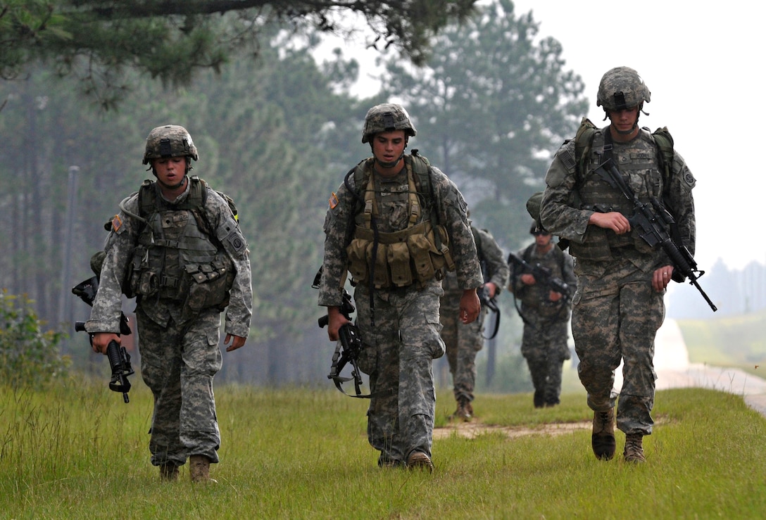 U.S. Army Spc. Stephen Segal, Sgt. Nathan Kaiser, and Pfc. Colby Mooney come to the end of a seven-mile road march that started the "Stress Shoot" competition at Fort Bragg, N.C., July 15, 2009. The event put the competitiors through a grueling series of physical challenges culminating in a marksmanship competition to see who could shoot the best under the most stressful conditions. The troops are assigned to the 82nd Airborne Division's Headquarters Troop, 1st Squadron, 73rd Cavalry Regiment, 2nd Brigade Combat Team.