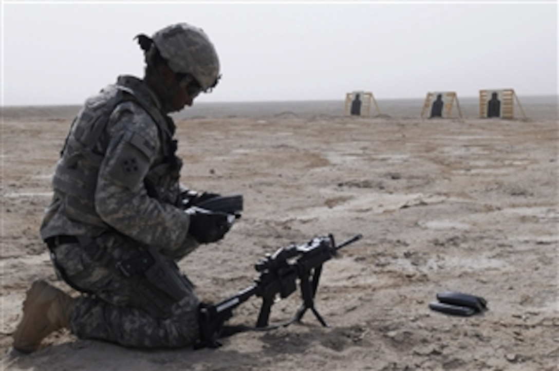 U.S. Army Cpl. Sara Thornton with Bravo Company, 445th Civil Affairs Battalion inspects her M-4 rifle magazines prior to participating in the tactical range training at Normandy Range Complex, Basra, Iraq, on July 15, 2009.  