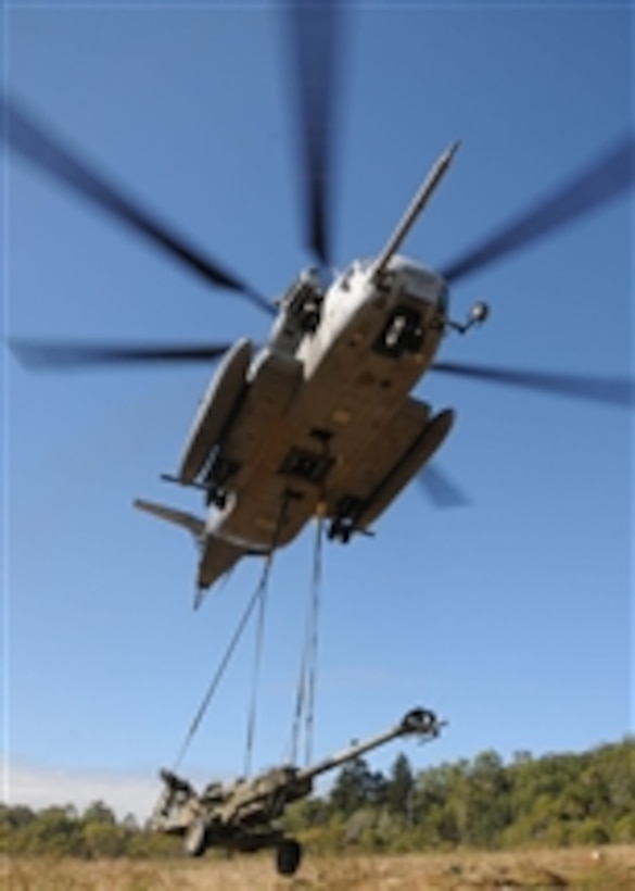 An MH-53E Sea Stallion helicopter, assigned to the Air Combat Element of the U.S. Marine Corps' 31st Marine Expeditionary Unit and embarked aboard the forward-deployed amphibious assault ship USS Essex (LHD 2), lifts an M777 155mm lightweight howitzer at Shoalwater Bay in Queensland, Australia, as a part of Talisman Sabre 2009 on July 19, 2009.  Talisman Sabre is a biennial, combined training exercise that trains U.S. and Australian forces in planning and conducting combined operations that will help improve combat readiness and interoperability between the countries' militaries.  