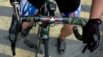An injured soldier holds the handlebars of his bicycle prior to Wounded Warrior Project Soldier Ride, New York City, July 23. The bicycle ride through Manhattan is part of the organization’s goal to raise awareness for those who have been injured while fighting overseas. (Marine Corps photo by Sgt. Randall A. Clinton)