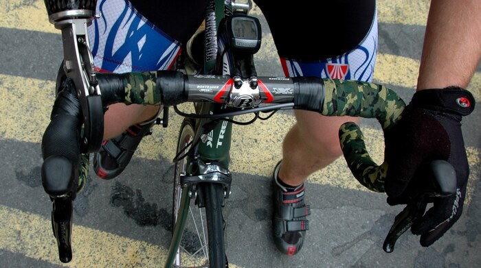 An injured soldier holds the handlebars of his bicycle prior to Wounded Warrior Project Soldier Ride, New York City, July 23. The bicycle ride through Manhattan is part of the organization’s goal to raise awareness for those who have been injured while fighting overseas. (Marine Corps photo by Sgt. Randall A. Clinton)