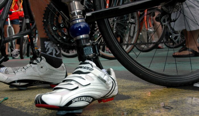 An injured soldier holds stands on the pedals of his bicycle prior to Wounded Warrior Project Soldier Ride, New York City, July 23. The bicycle ride through Manhattan is part of the organization’s goal to raise awareness for those who have been injured while fighting overseas. (Marine Corps photo by Sgt. Randall A. Clinton)