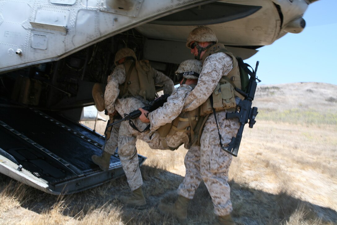 Marines from the 4th Light Armored Reconasaiance Battalion load a simulated casualty onto a CH-46E "Sea Knight" during a casualty evacuation excercise aboard Marine Corps Base Camp Pendleton July 22.