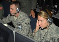 NELLIS AIR FORCE BASE, Nev. -- Airman 1st Class Mitch Smith (left) works in the Combined Air Operations Center-Nellis alongside fellow Air National Guard members from the 103rd Air and Space Operations Group, Bradley Air National Guard Base, Conn. Airman Smith works in the Joint Personnel Recovery Center during Red Flag. (U.S. Air Force photo/2nd Lt. Emily Chilson)