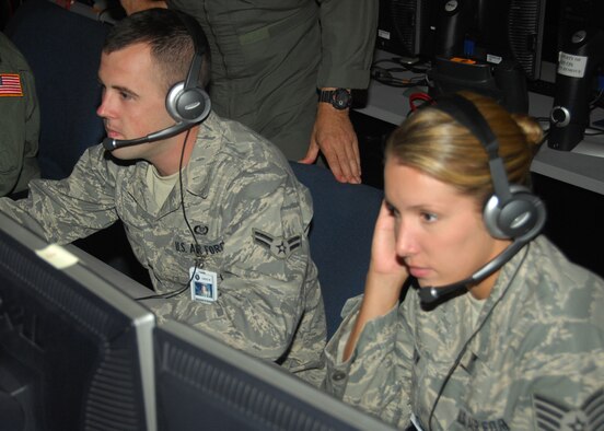NELLIS AIR FORCE BASE, Nev. -- Airman 1st Class Mitch Smith (left) works in the Combined Air Operations Center-Nellis alongside fellow Air National Guard members from the 103rd Air and Space Operations Group, Bradley Air National Guard Base, Conn. Airman Smith works in the Joint Personnel Recovery Center during Red Flag. (U.S. Air Force photo/2nd Lt. Emily Chilson)