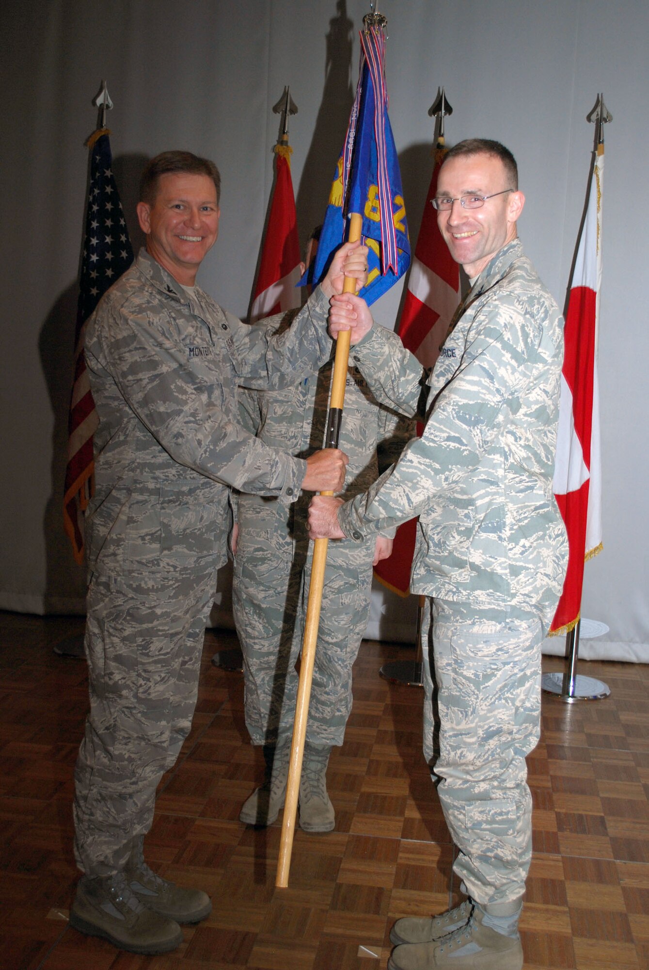 Col. Chris Gentry takes command of the 821st Air Base Group during a change of command ceremony at the Top of the World Club July 23. Col. Wayne Monteith, 21st Space Wing vice commander, was the presiding officer (Photo by 1st Lt. Lisa Meiman).