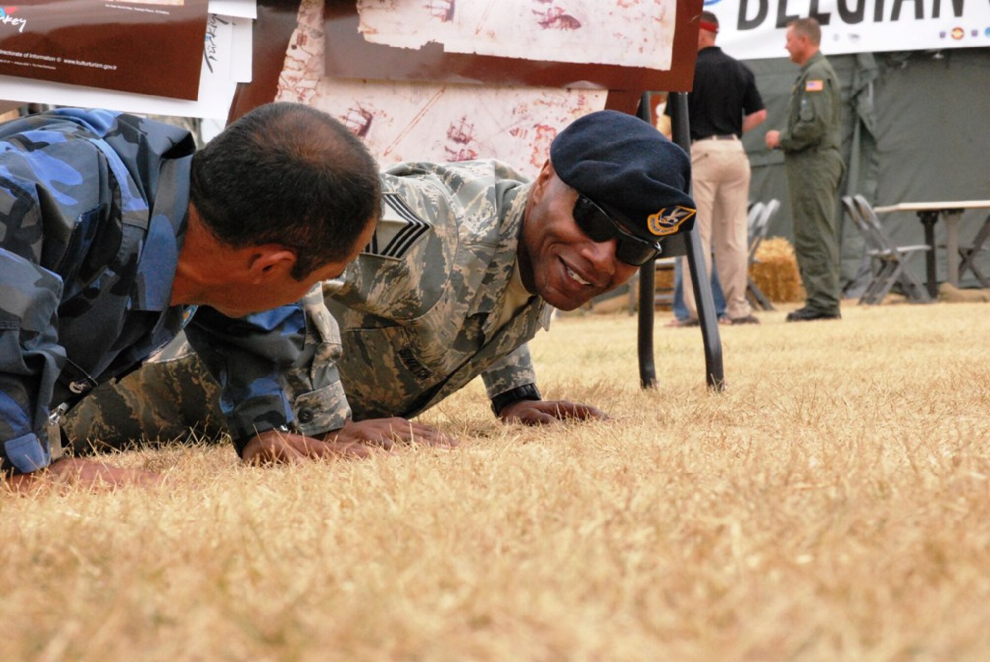 Airman Erdogan Kaya (left) of the Turkish air force has a friendly push-up competition with Chief Master Sgt. Larry Similton, from the 62nd Airlift Wing at McChord Air Force Base, Wash., in Rainier Ranch during Air Mobility RODEO 2009 July 23.  Chief Similton won the push-up challenge and shared strength building strategy with the Turkish airman.  (U.S. Air Force Photo/Master Sgt. Collen McGee)