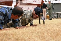 Airman Erdogan Kaya (left) of the Turkish air force has a friendly push-up competition with Chief Master Sgt. Larry Similton, from the 62nd Airlift Wing at McChord Air Force Base, Wash., in Rainier Ranch during Air Mobility RODEO 2009 July 23.  Chief Similton won the push-up challenge and shared strength building strategy with the Turkish airman.  (U.S. Air Force Photo/Master Sgt. Collen McGee)