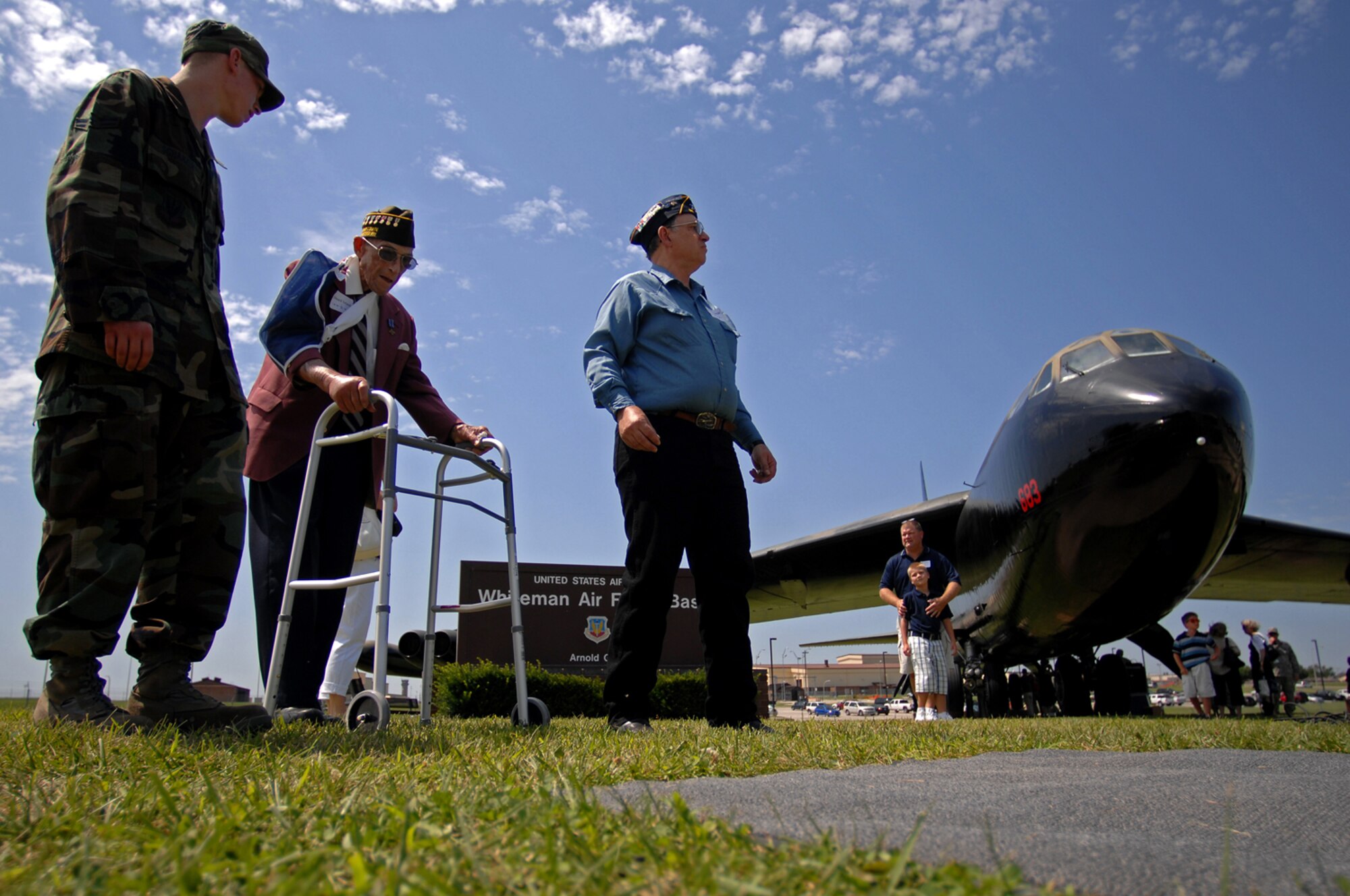 WHITEMAN AIR FORCE BASE, Mo. - Edward Ireland, a retired Air Force Tech Sgt., who served for 17 years and fought in World War II talks with a young Airman July 24 after attending a B-52 static display ceremony which was dedicated to Capt. Robert Morris Jr. and the crew of Ebony-02 who flew during Operation Linebacker II during the Vietnam War. Many veterans associations were in attendance Friday as well as members of Team Whiteman. (U.S. Air Force photo Senior Airman Kenny Holston)