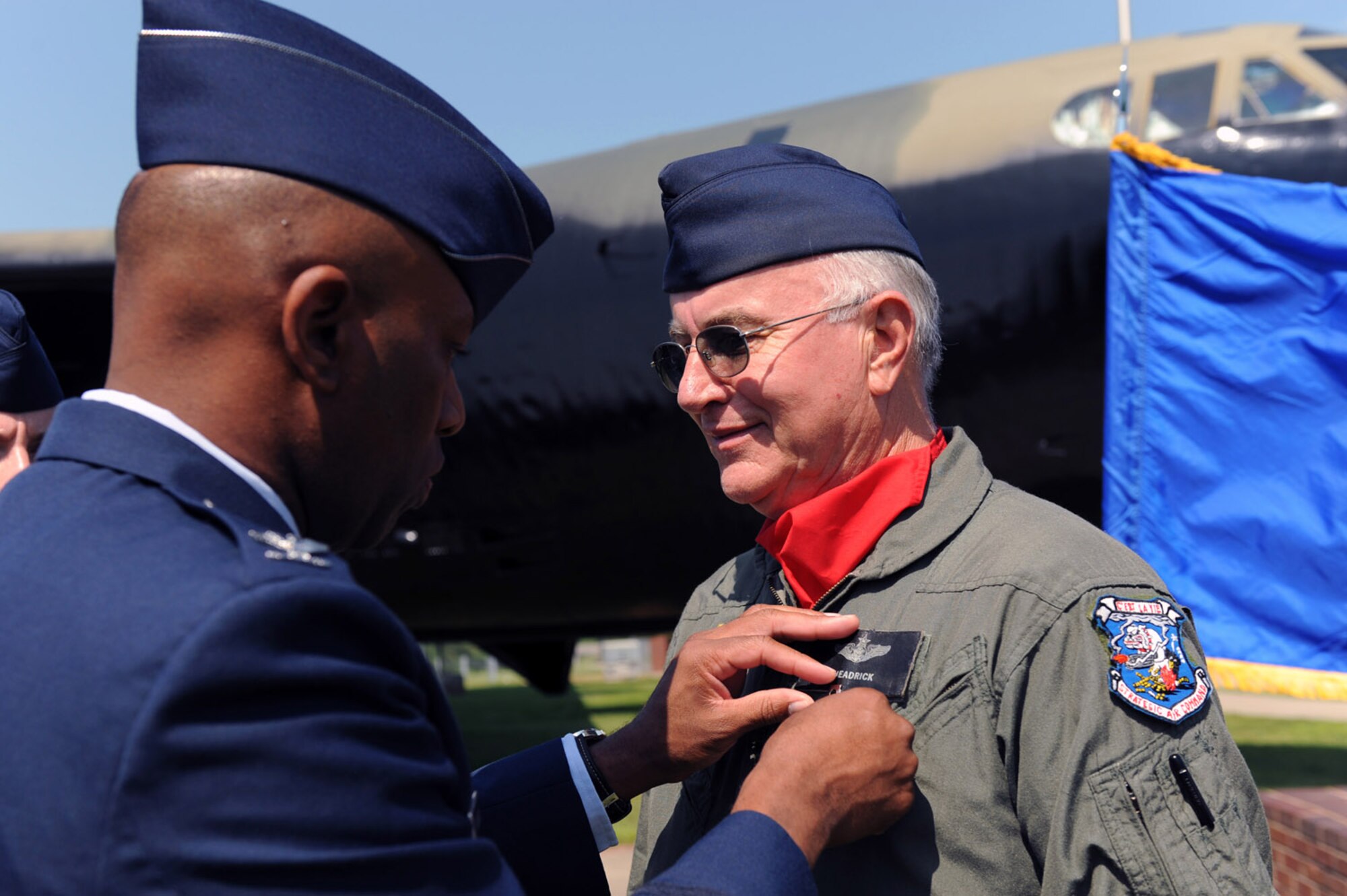 WHITEMAN AIR FORCE BASE, Mo. - Col. Rickey Rodgers, 509th Bomb Wing vice commander, presents a Distinguished Fly Cross medal to Master Sgt. (Ret.) Jerry Headrick at the B-52 dedication ceremony July 24. A B-52 static display was dedicated to Capt. Robert J. Morris Jr. who flew during Operation Linebacker II during the Vietnam War. Many veterans associations were in attendance Friday as well as members of Team Whiteman. (U.S. Air Force photo/Senior Airman Jason Huddleston)