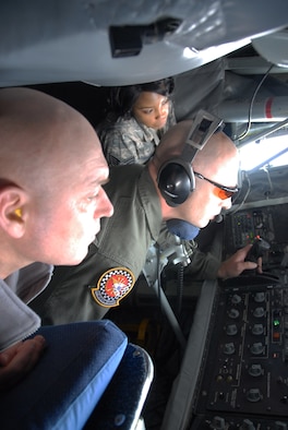 Maj. Russell Wilmot, 477th Fighter Group Operations Support Flight, and Staff Sgt.  Danielle Foster, a medic from the 302nd Fighter Squadron, watch as Tech. Sgt. Josh Welch, a boom operator from the 434th Air Refueling Wing, refuels an F-22A Raptor.  Maj. Wilmot and Staff Sgt. Foster were two of 14 personnel from the 477th FG and 3rd Wing who flew on a KC-135 Stratotanker orientation flight July 14. The crew from the 434th ARW came up to Elmendorf Air Force Base from Grissom Air Reserve Base, Indiana to support the 477th FG's first-flying Unit Training Assembly in July.  They flew several personnel and spouses from the 477th FG and the 3rd Wing here on two orientation flights, showcasing the KC-135 and F-22 refueling capabilities and how the units work together in flight. (Air Force Photo / Maj. Cary McPartlin)